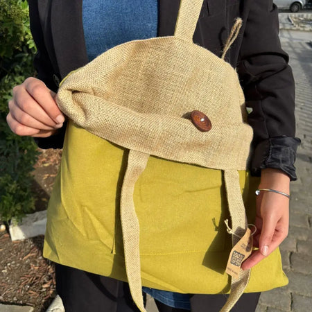 Beige and olive green canvas tote bag with wooden button closure made from jute and cotton materials