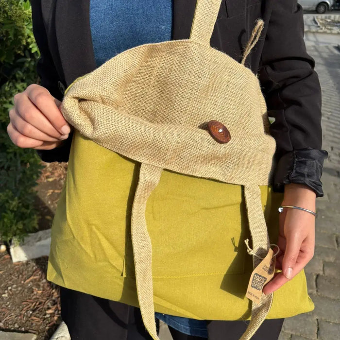 Beige and olive green canvas tote bag with wooden button closure made from jute and cotton materials