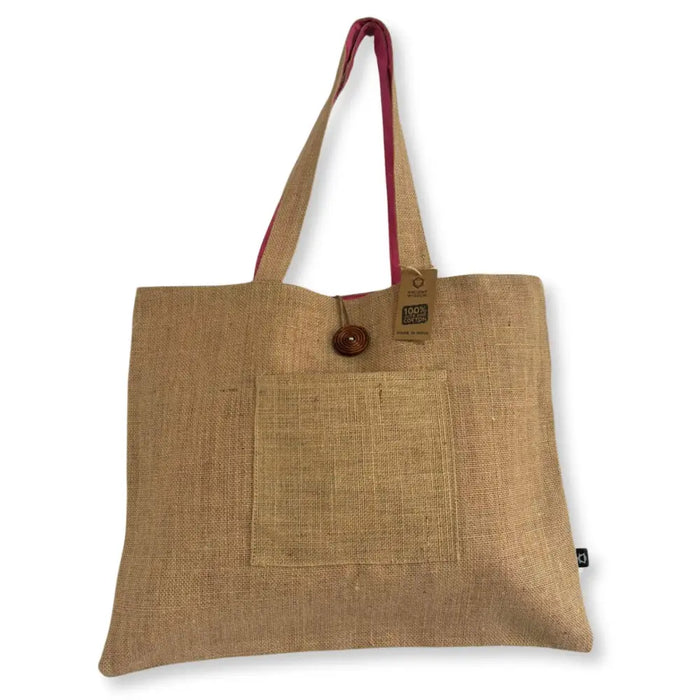 Natural fiber tote bag in pistachio with pink handles and wooden button closure made from jute and cotton materials