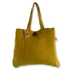 A mustard-yellow jute and cotton tote bag with matching handles and a front pocket with wooden button closure