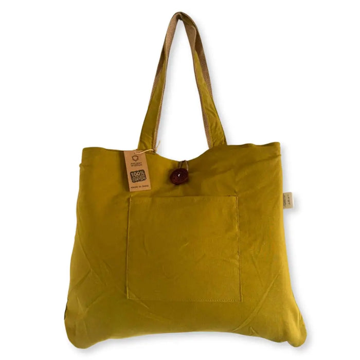 A mustard-yellow jute and cotton tote bag with matching handles and a front pocket with wooden button closure