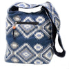 Kathmandu big bag dusk with blue woven fabric, white and gray geometric patterns, featuring a black zipper pocket with an orange bead