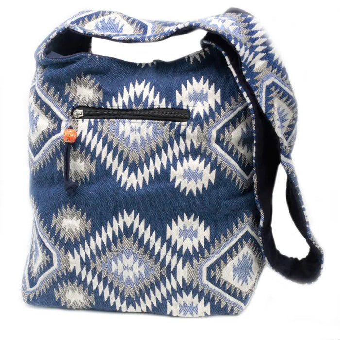 Kathmandu big bag dusk with blue woven fabric, white and gray geometric patterns, featuring a black zipper pocket with an orange bead