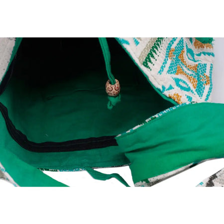 Green patterned kathmandu big drawstring bag with fabric exterior and embroidered bead on cord in midday color