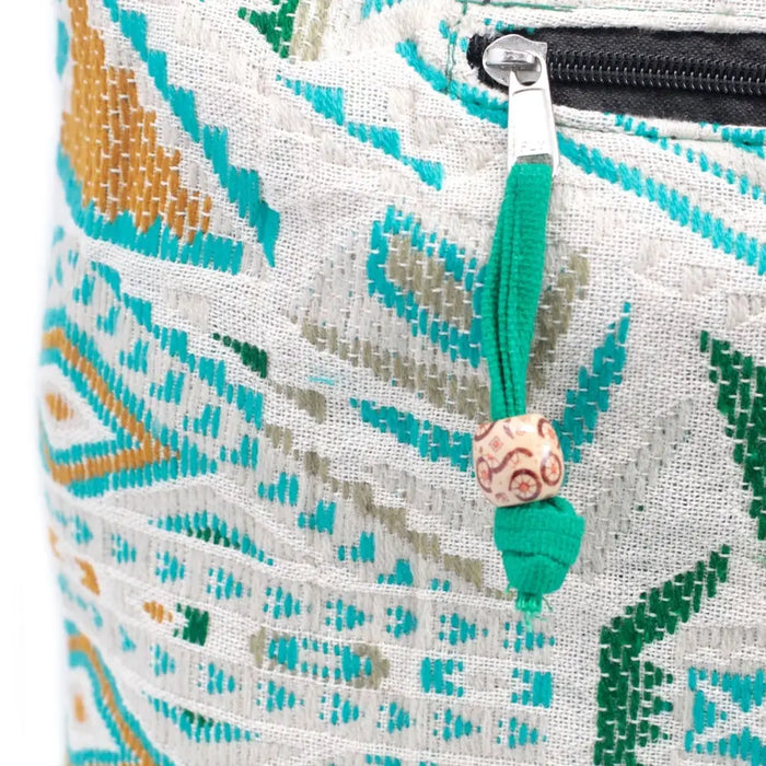 A kathmandu big woven fabric pouch in turquoise green and beige with a black zipper and teal tassel detail