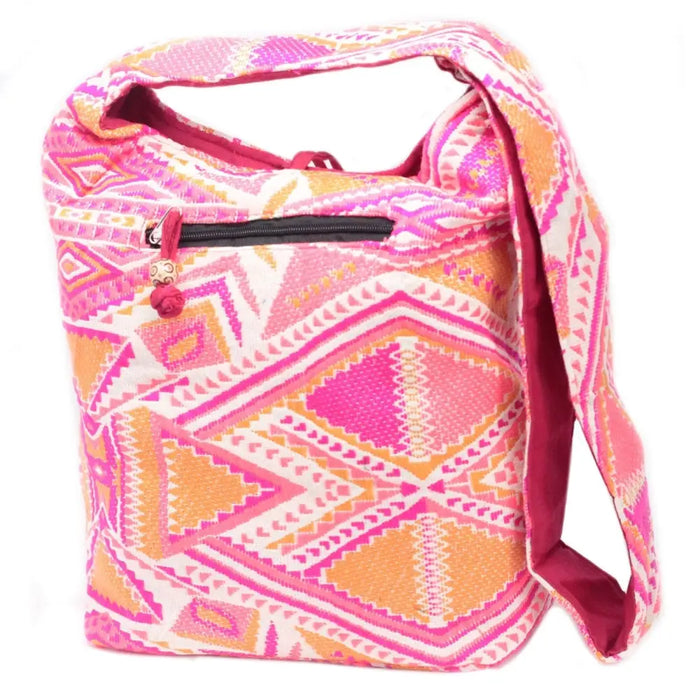 A kathmandu big bag with vibrant pink and orange geometric woven pattern and magenta interior lining