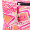 A kathmandu big woven bag in pink and orange geometric pattern with black zipper and red cord charm with wooden bead