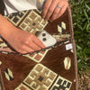 Brown and cream geometric patterned woven pouch with a clear phone case inside part of kilim summer messenger bag chocolate