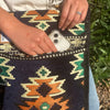 Dark navy kilim summer messenger bag with dark blue woven textile and orange green cream geometric patterns