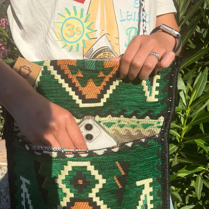Kilim summer messenger bag with green and orange geometric woven pattern and black trim made from fabric