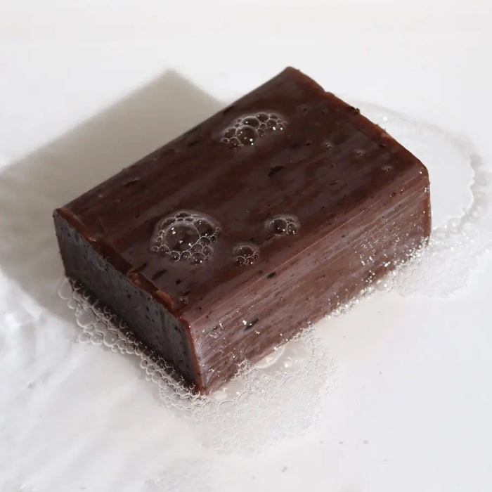 Dark brown rectangular klay soap bar with glossy surface and bubbles scented with lavandula angustifolia lavender vanilla