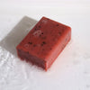 Klay soap orange and ginger is a rectangular red bar soap with black speckles made with yellow clay and peel oil