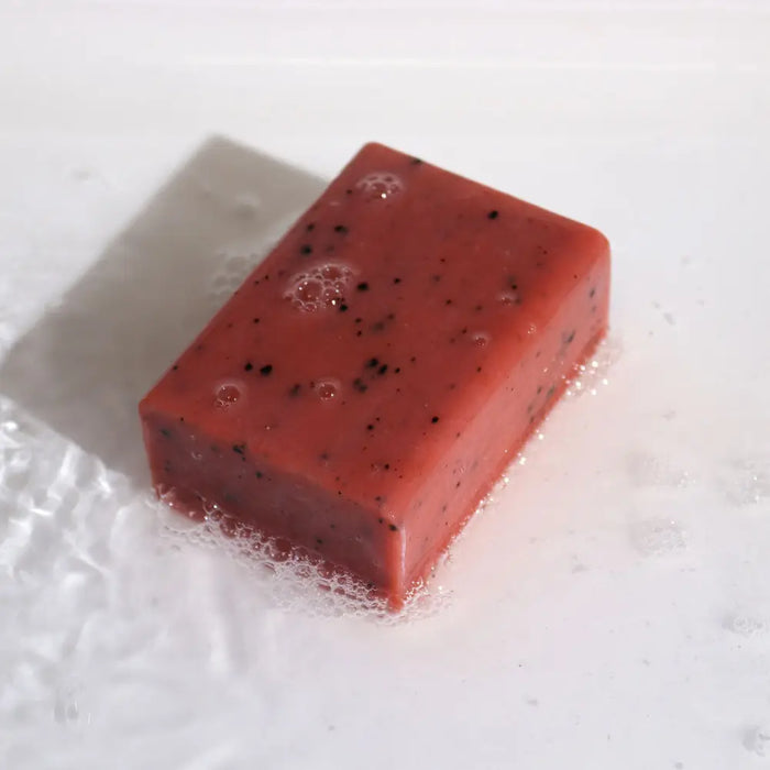 Klay soap orange and ginger is a rectangular red bar soap with black speckles made with yellow clay and peel oil