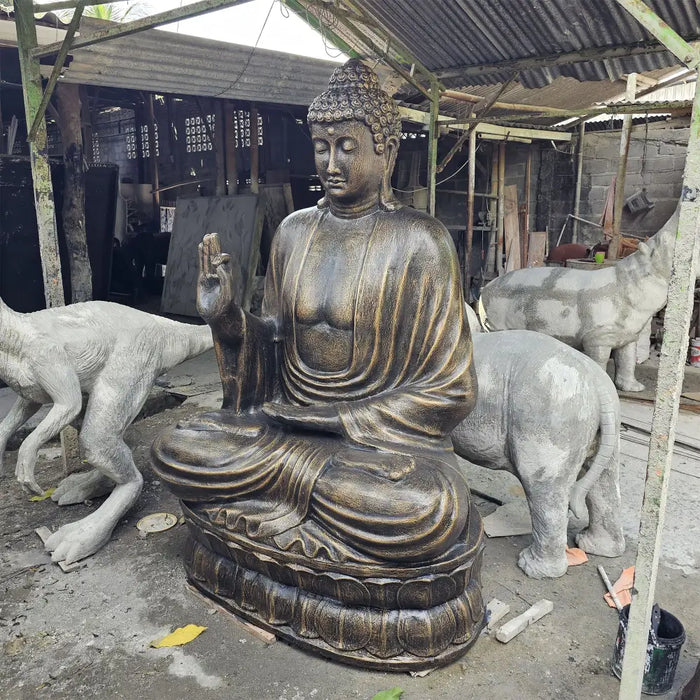 Large antique gold bronze buddha statue with intricate details and serene expression seated on lotus base