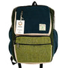 Large boxy hemp backpack in teal and sage with textured fabric panels and beige trim made from natural materials