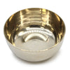 A large brass singing bowl with a polished reflective interior and subtle horizontal ridges on the exterior