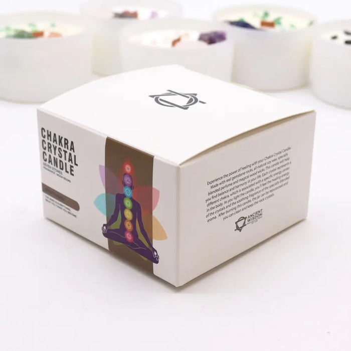 White cardboard box with chakra crystal candle featuring colorful meditating figure and seven chakras illustration