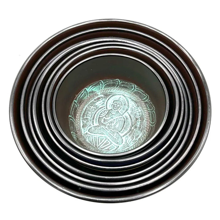 Set of seven singing bowls in teal and silver with a large chakra design featuring a blue bowl at the center