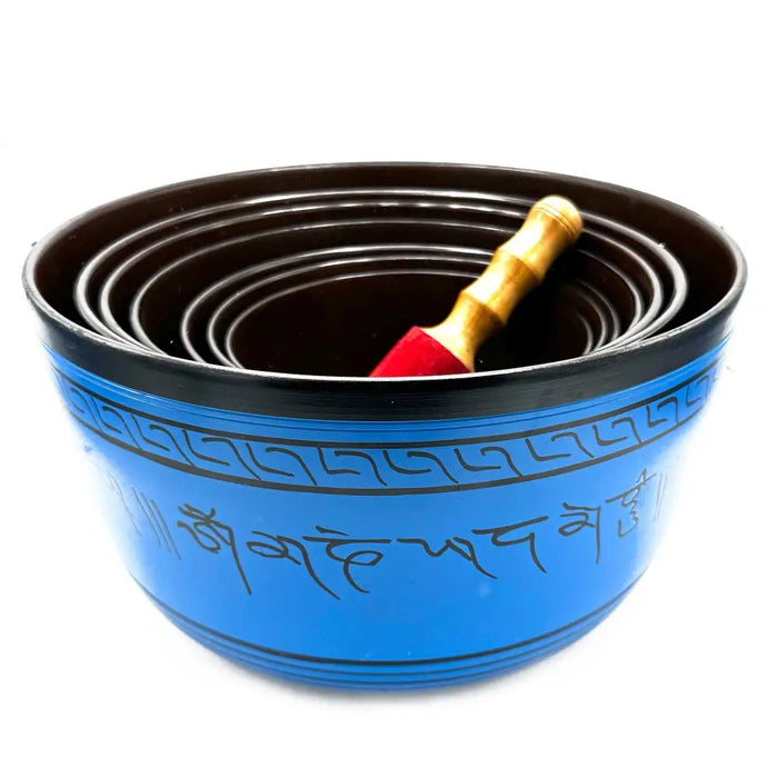 Large chakra blue bowl with sanskrit script and black bands from seven singing bowls set with wooden mallet