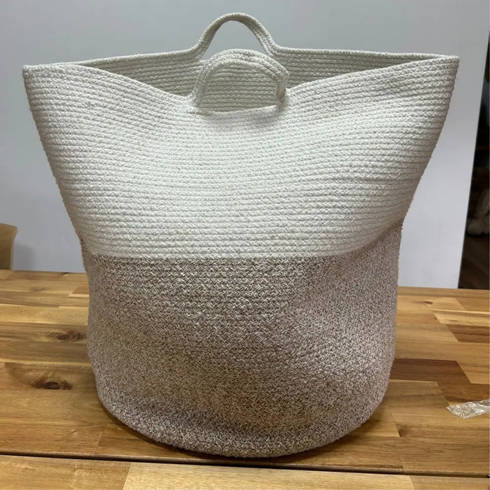 Large cotton rope laundry basket with two-toned texture white upper half and beige lower half with handles
