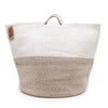 A large cotton rope laundry basket in beige and white with sturdy handles and an indian dolly brand tag