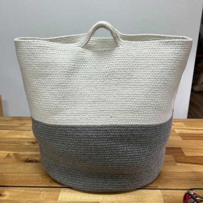 Large cotton rope laundry storage basket in white and gray with a textured woven design and two-toned color scheme