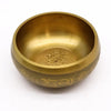 Large ganesh singing bowl made of golden brass with intricate engravings and sanskrit script for singing use