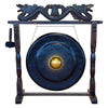 Large dark blue gong with golden center on an antique brown wooden stand featuring carved dragon heads