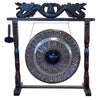 A large black wooden stand with carved dragon motifs holding a patterned 80cm metal gong with leaf engravings