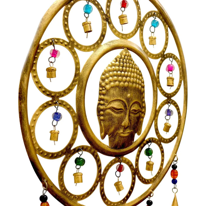 Golden brass buddha face wall hanging with circular rings and colorful beaded bells for meditation spaces
