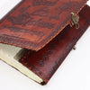 A large dark tan leather notebook with embossed designs and a brass clasp for use as a book of shadows