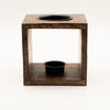 Dark wood cube-shaped mango wood oil burner with black top and base bowl featuring buddha face design