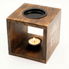 Dark wood mango wood oil burner cube with black well top and engraved buddha face design for aromatherapy