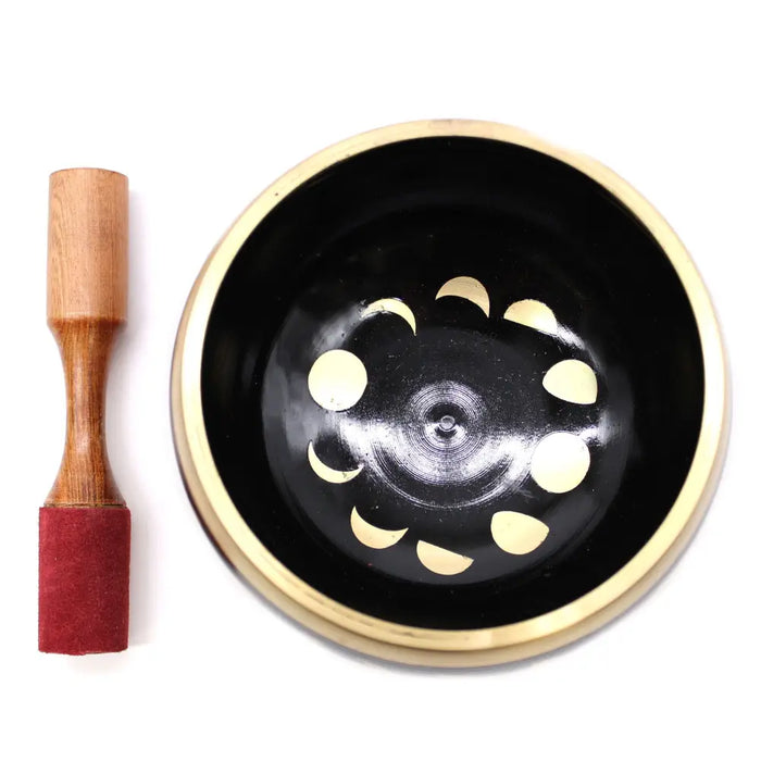 Black and gold Tibetan singing bowl set with moon phase design and wooden mallet for release negative emotions