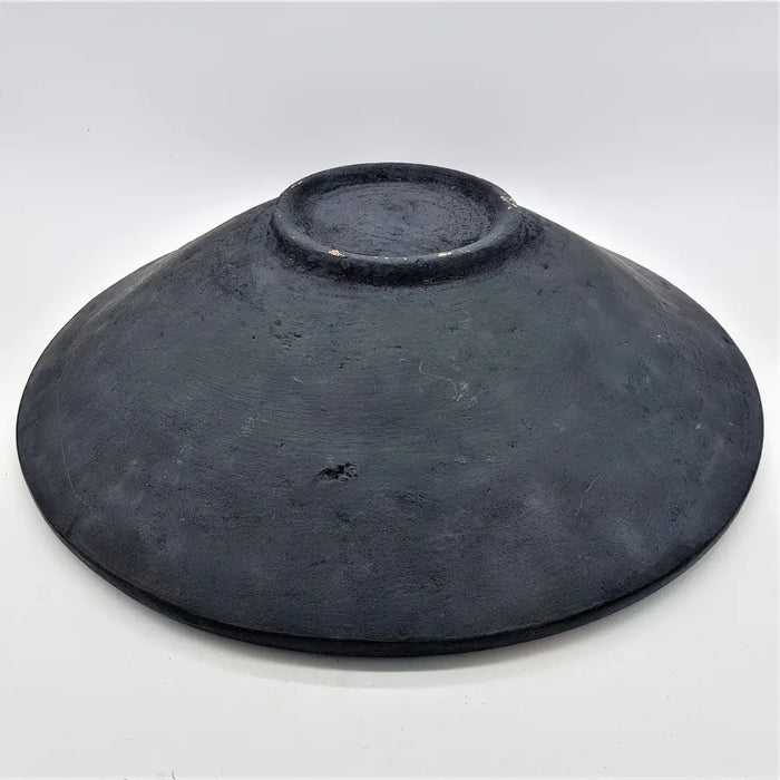 Large mosaic tile dish in dark gray textured ceramic with a raised rim and uneven surface