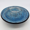 Large mosaic tile dish with a circular blue gradient pattern accented by silver and black tiles on the rim