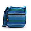 Large nepal sling bag with woven blue and green stripes and a black zipper pull with wooden toggle detail