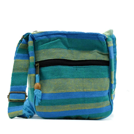 Large nepal sling bag with blue and green striped woven fabric black zipper pull and wooden toggle spring meadows design