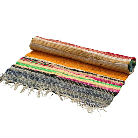 Large rag rug with colorful rainbow colours and fringed edges handwoven in vibrant orange pink green black and gray stripes