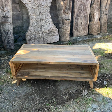 Large round edged coffee table with two-tier design and natural wood grain finish made from recycled wood
