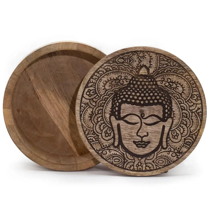 A large round wooden box with a black engraved lid featuring a detailed buddha face and intricate mandala patterns