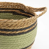 A large woven cotton basket with natural tan, black, and olive green stripes and integrated handles in a set of 3