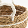Natural woven seagrass basket with cotton handles and white stripes decorative band in a set of 3 baskets