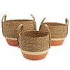 Set of three large seagrass and straw baskets with natural and orange terracotta bands and varying diameter sizes