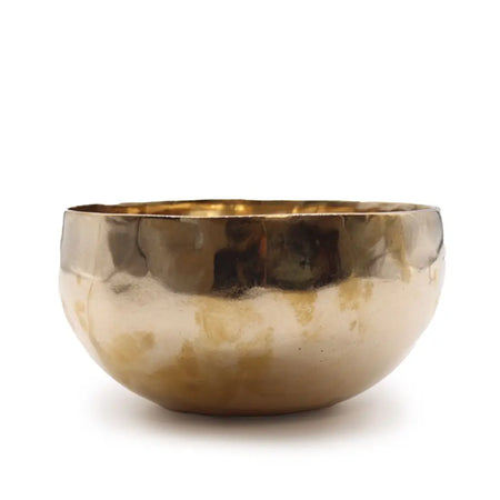 Large shining bell-metal handmade singing bowl with hand-hammered brass, warm golden interior, and textured matte exterior