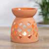 Large terracotta ceramic oil burner with intricate quatrefoil cutouts for home decor and aromatherapy use