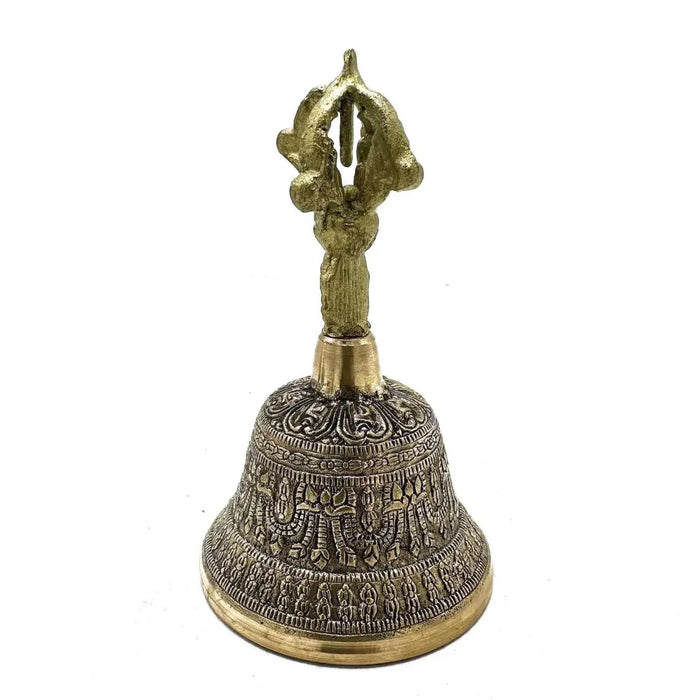 Large brass tingsha bell with intricate engraved patterns and a decorative handle for Tibetan rituals