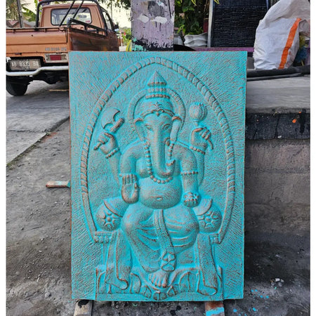 Large turquoise ganesha relief carved from stone showing the hindu deity ganesha in a decorative wall panel design