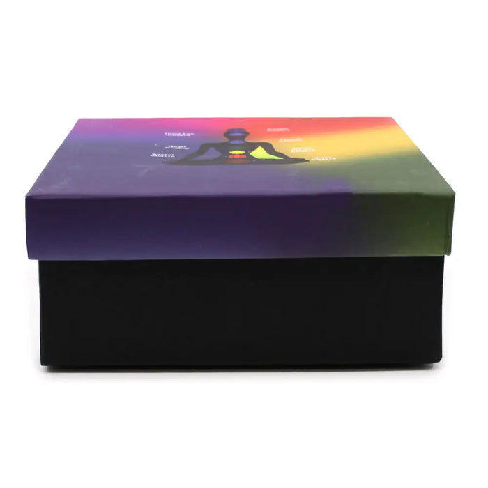 A large yin yang singing bowl set with a black box featuring a rainbow top and a meditating figure illustration