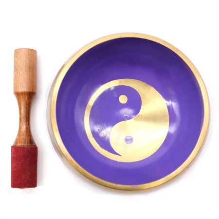 Large purple brass singing bowl set with gold yin yang symbol and wooden mallet with red rubber tip